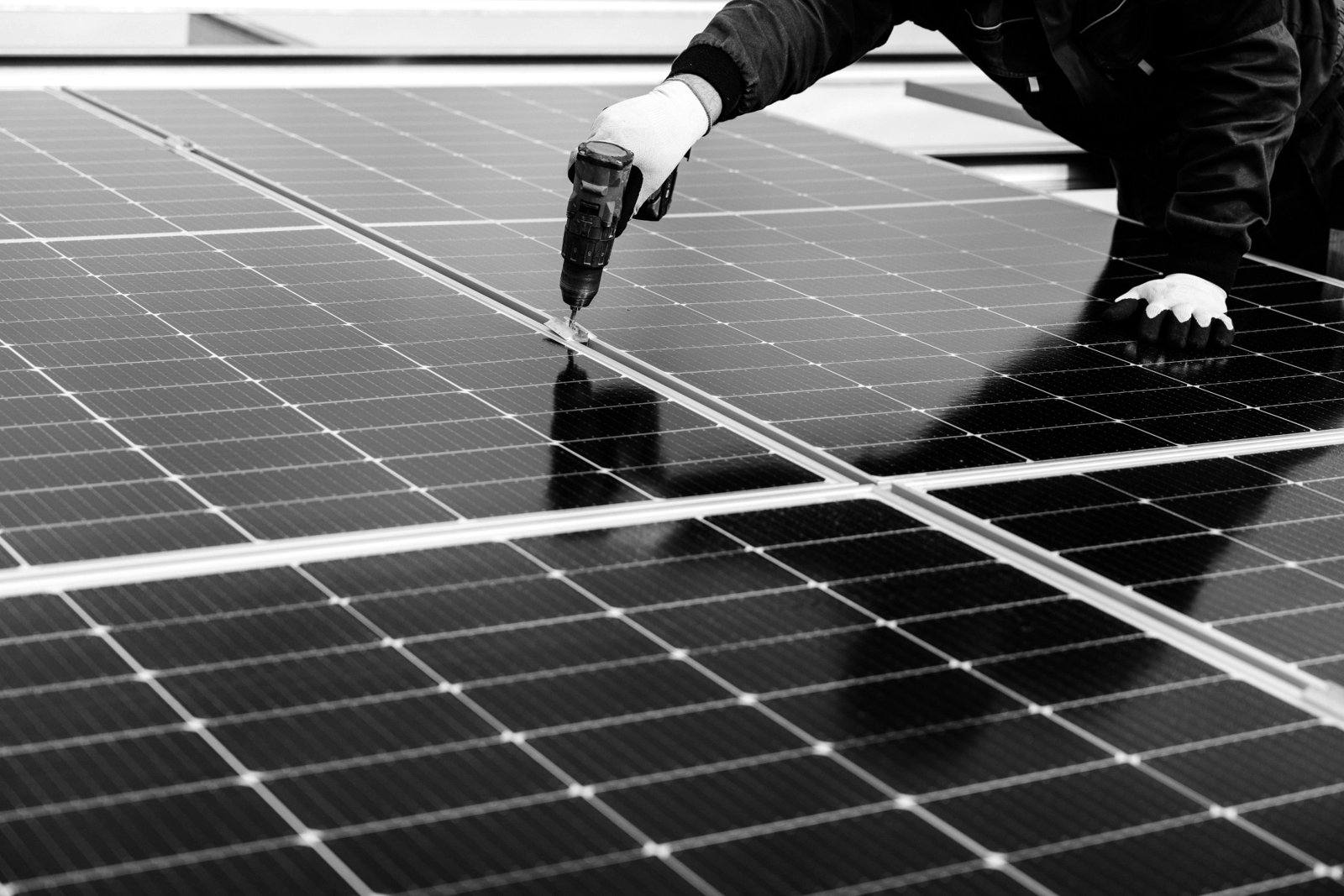 Technician fixing a solar panel