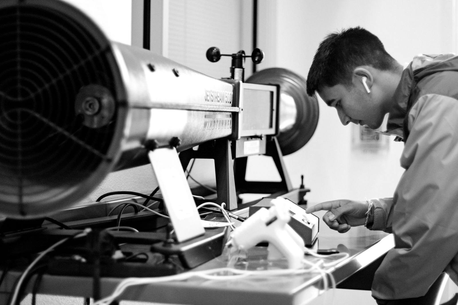 Engineer testing a prototype in a wind tunnel